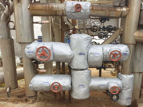 Removable reusable blanket and jacket insulation installed on outdoor PRV station in chemical plant