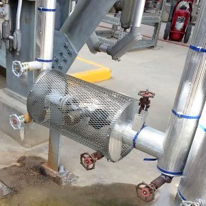 Metal mesh safety guard installed around a hot steam trap
