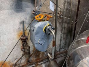 TAS removable insulation blanket installed on a steam trap station in an industrial steam system