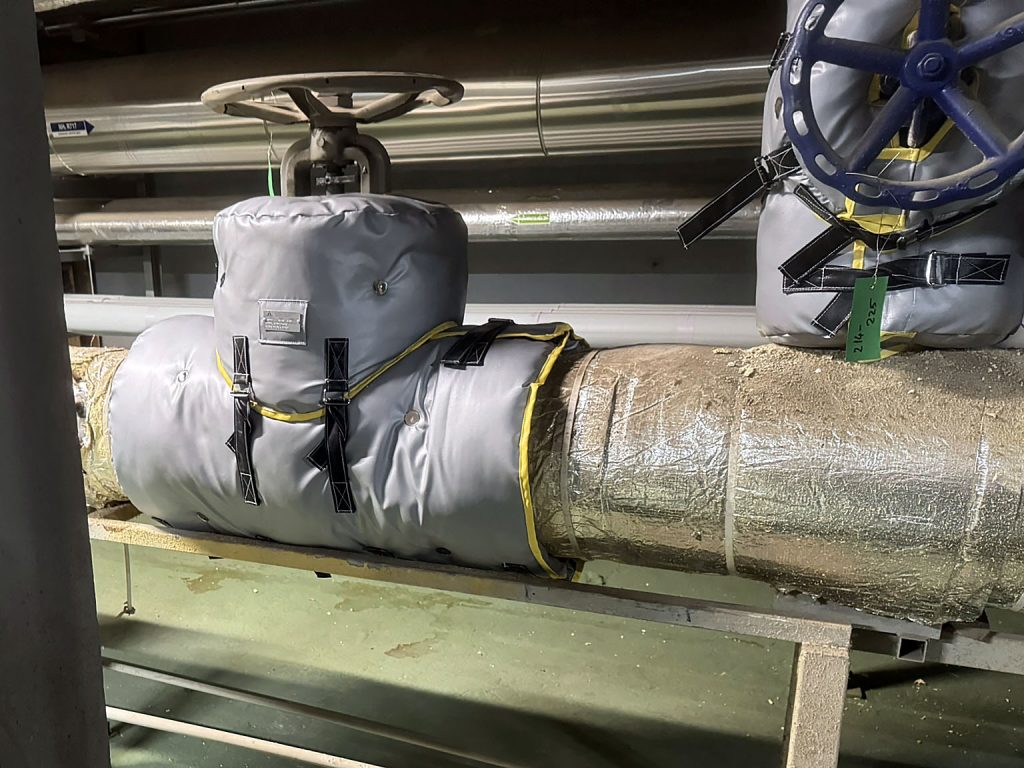 Custom removable blanket insulation with insulated end caps installed on an industrial valve