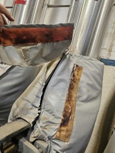 Damaged removable blanket insulation showing fabric degradation caused by excessive internal air circulation and overheating