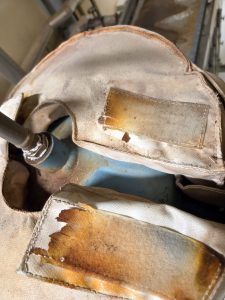 Damaged hook-and-loop fastener on a removable insulation blanket in an industrial environment