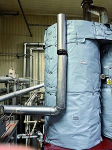Removable insulation blankets installed on large process equipment in an industrial facility