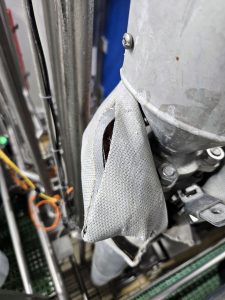 Damaged removable insulation blanket with an open seam exposing internal insulation